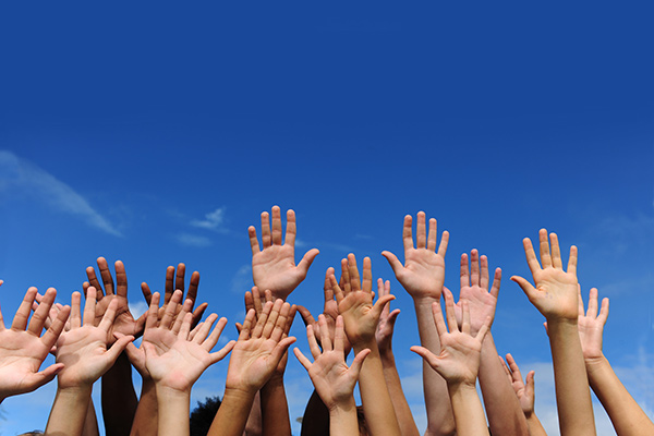 Photo of many hands in the air - Learn more about multi-ethnic skincare