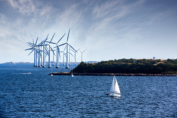 white Wind turbines in the ocean