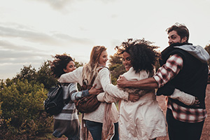 Group of people walking arm-in-arm