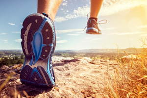 Shot from below of someone running on a trail