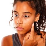 Young woman applying foundation - learn about formulation multifunctional cosmetics in the Prospector Knowledge Center.