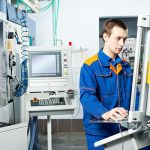 Man working at machine tool. Learn how to read material data sheets in the Prospector Knowledge Center.