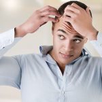 Man looking at hair loss - Learn the facts about hair growth technology