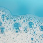 Bubble foam on blue water surface - Learn more about defoamers here.