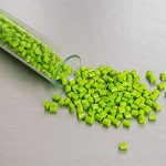 Green beads spilling out of a vial