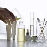 Chemists hand pouring liquid into a beaker