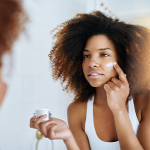 Woman putting on lotion