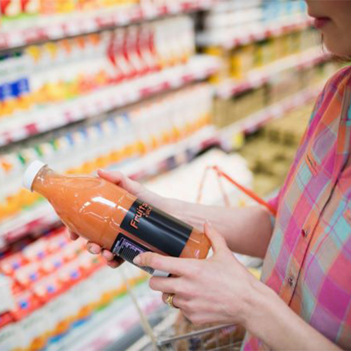 A person looking at the label on a bottle