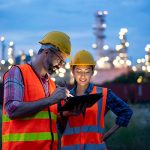 Workers at a plant using a tablet