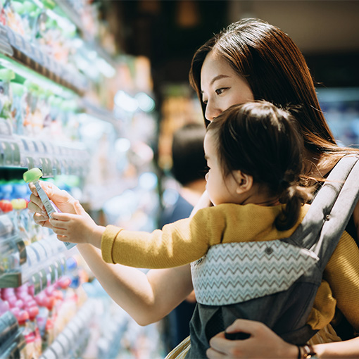 Young mother and baby in grocery store