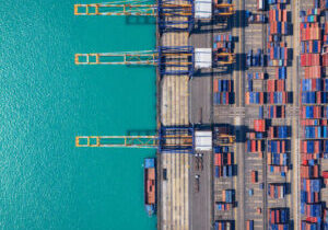Aerial view of Containerized Cargo Handling and Freight Transportation. Industrial import-export port prepare to load containers.