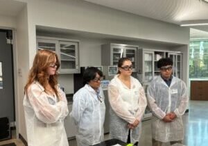 Students shadowing paint chemists performing dry film property testing