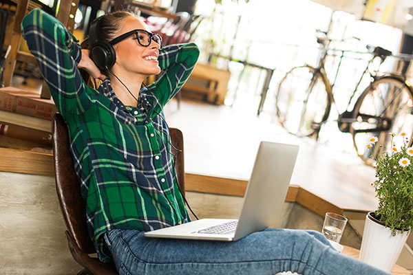 Woman on laptop - learn about the effect of artificial visible light (AVL) on skin in the Prospector Knowledge Center.