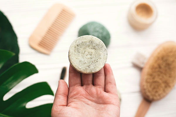 photo of a person holding a shampoo bar - Learn how to make shampoo bars