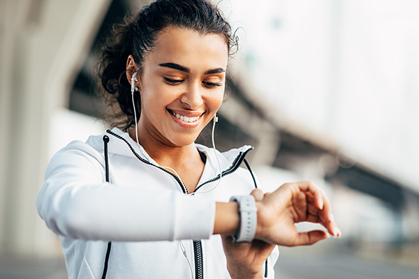 Woman looking at smart watch - Learn what CES shows as technology trends