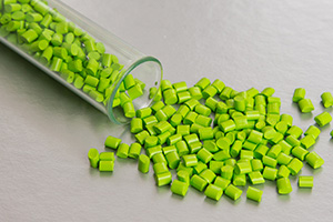 Green beads spilling out of a vial