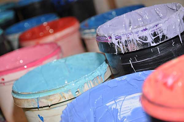 Image of large paint buckets with colorful paint - Learn about Dispersants for Electrostatic Stabilization in the Prospector Knowledge Center.