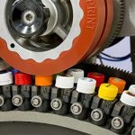 Henniker Plasma PAD Printing machine and plastic bottle lids which have been plasma treated before printing - learn more about plasma processing in the Prospector Knowledge Center.