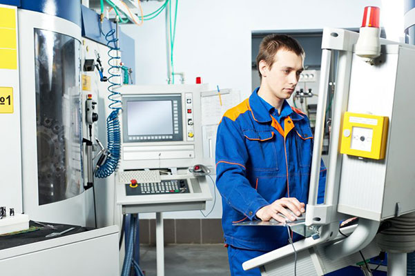 Man working at machine tool. Learn how to read material data sheets in the Prospector Knowledge Center.