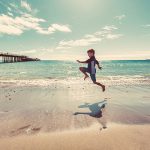 Boy skipping on beach - find tips on using waterproof enhancing technologies in sunscreen formulations in the Prospector Knowledge Center.