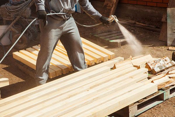Man applying flame-retardant coating - learn about formulating fire-retardant coatings in the Prospector Knowledge Center.