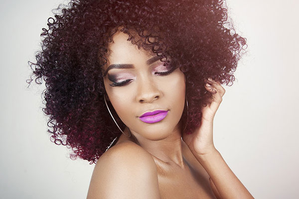 Woman with curly hair - learn the benefits and key ingredients in an effective hair conditioner formulation, plus current trends, in the Prospector Knowledge Center.