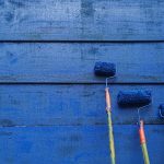 Paint rollers on blue painted wall - learn about how to lower VOCs in paint formulations in the Prospector Knowledge Center.