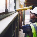 Woman using a sealant - find out more about caulks and sealants here