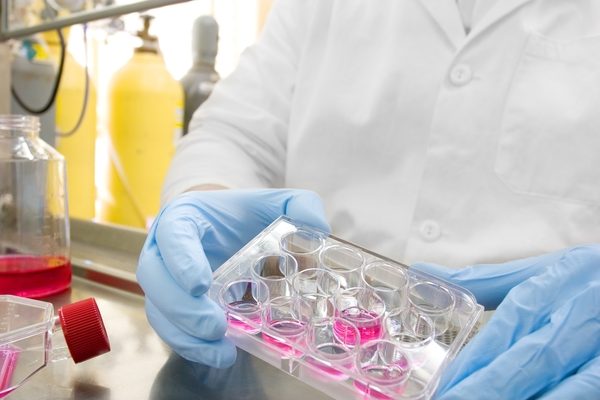 Scientist in lab with test tubes