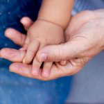 elderly person holding a baby's hand - Learn about free radicals and quench technology