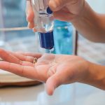 woman applying hand sanitizer - Learn more about hospital-grade hand sanitizers