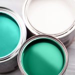 Photo of green and white paint in cans - Learn the difference between wetting agents and dispersants