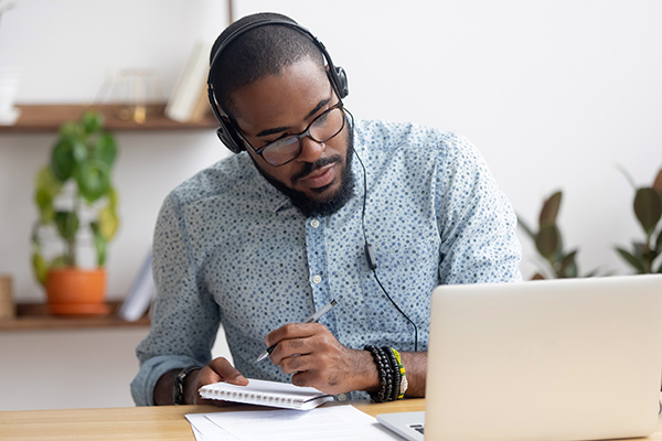 man watching a webinar -How to get the most information from a webinar