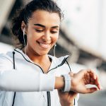 Woman looking at smart watch - Learn what CES shows as technology trends