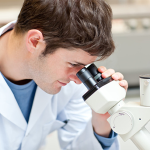 Man looking into microscope