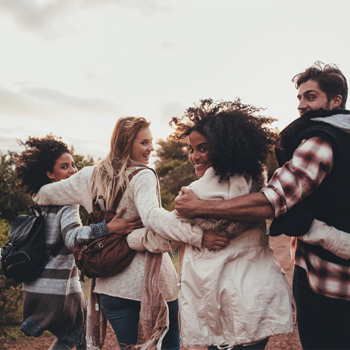 Group of people walking arm-in-arm
