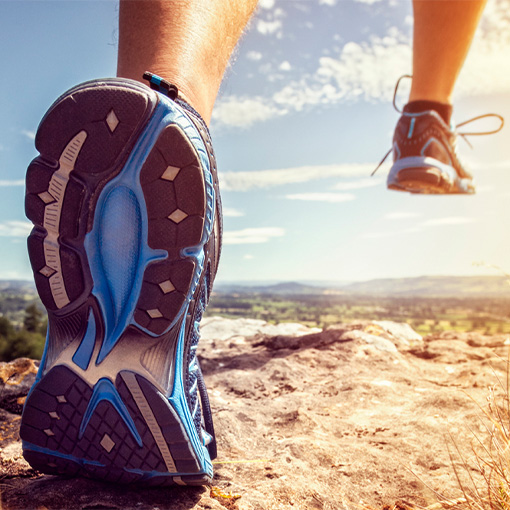 Shot from below of someone running on a trail