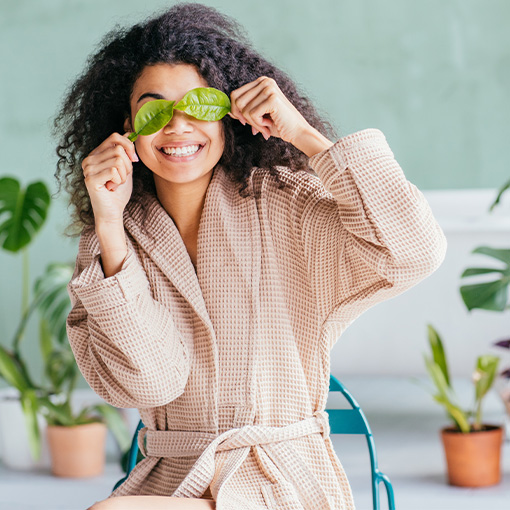 Woman with leaves over her eyes