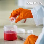 Lab worker pouring liquid