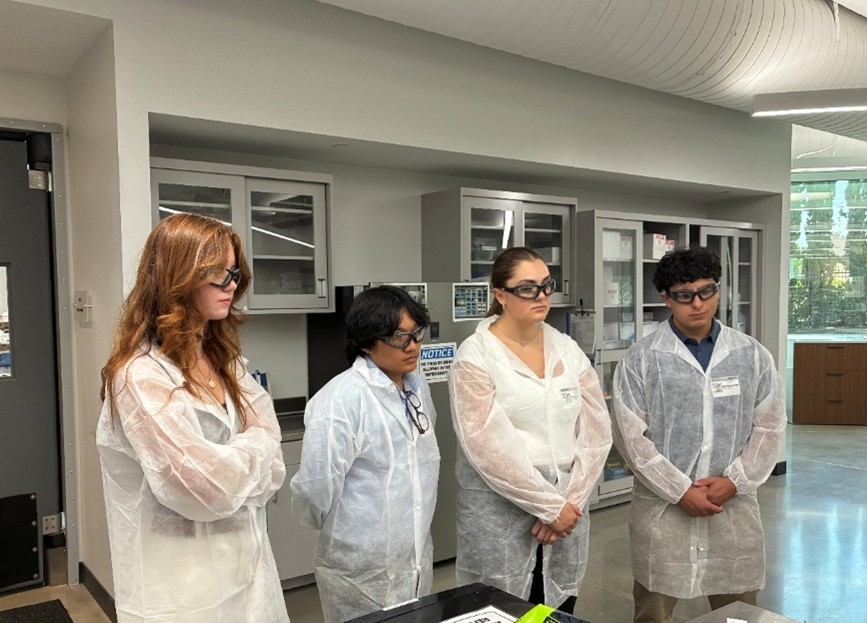 Students shadowing paint chemists performing dry film property testing