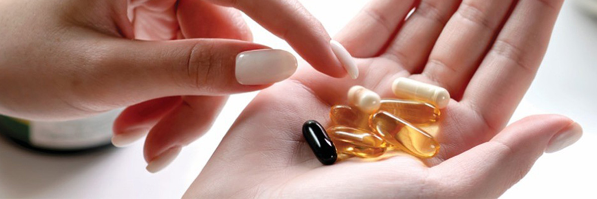 Hand holding pills