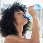 Woman drinking from water bottle