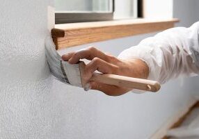 person-paintint-a-wall-iStock-1007607572-600x400-wp