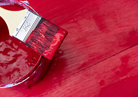 red paint can and brush